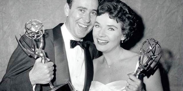 Writer Carl Reiner and actress Polly Bergen pose with their Emmy Awards statuettes on April 15, 1958, in New York City.