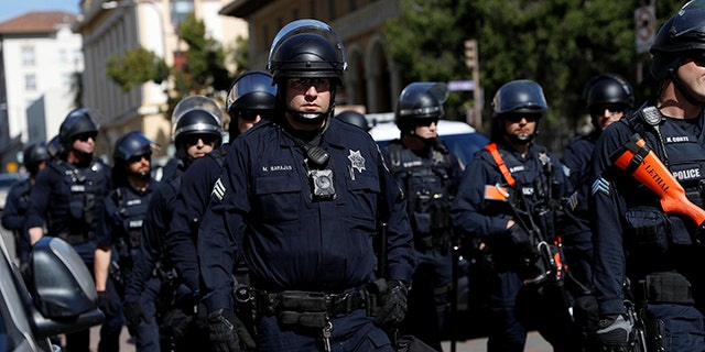 Police in riot gear standing at the ready as opposing factions gather over the cancellation of conservative commentator Ann Coulter's speech at the University of California, Berkeley, last April.