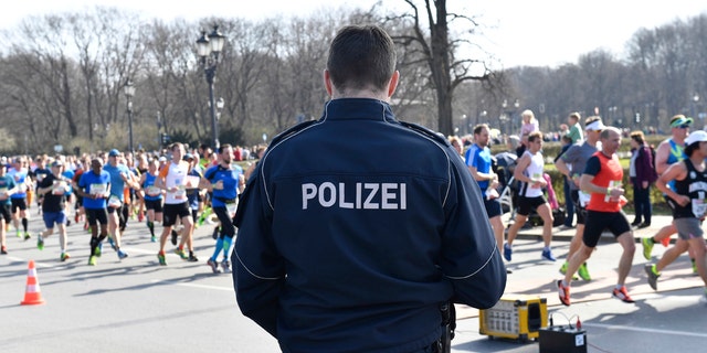 Police guard during the half marathon run in Berlin, Sunday, April 8, 2018. The German daily Die Welt is reporting that police have foiled a knife attack on a half-marathon in Berlin.