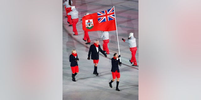 Tucker Murphy carries the flag of Bermuda during the opening ceremony of the 2018 Winter Olympics in Pyeongchang, South Korea, Friday, Feb. 9, 2018. (AP Photo/Matthias Schrader)