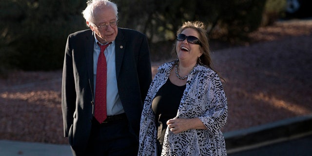 Democratic presidential candidate Sen. Bernie Sanders, I-Vt., and wife, Jane, share a light moment as they stroll around a parking lot after arriving at the at the McCarran International Airport Thursday, Feb. 18, 2016, in Las Vegas. (AP Photo/Jae C. Hong)