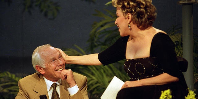 Entertainer Bette Midler caresses talk show host Johnny Carson during his next-to-last taping of "The Tonight Show" in Burbank, Ca., Thursday, May 21, 1992.