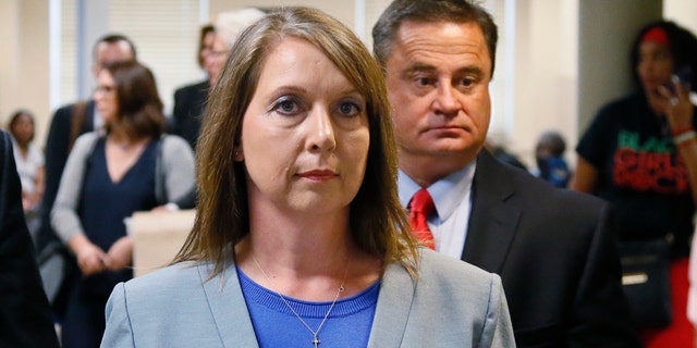 Betty Shelby leaves the courtroom with her husband, Dave Shelby, right, after the jury in her case began deliberations in Tulsa, Okla., Wednesday, May 17, 2017. Shelby is charged with manslaughter in the shooting of Terence Crutcher, an unarmed black man. (AP Photo/Sue Ogrocki)