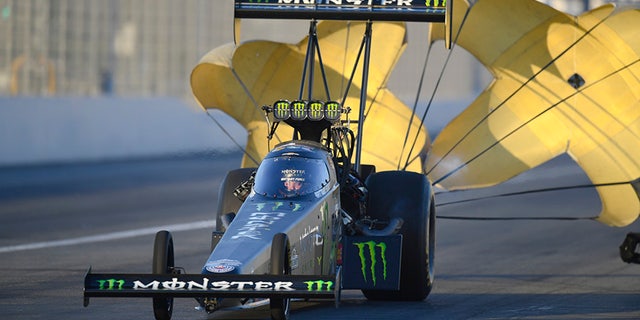 In this photo provided by the NHRA, Brittany Force slows after a run in Top Fuel qualifying at the Auto Club NHRA Finals drag races at Auto Club Raceway, Saturday, Nov. 11, 2017, in Pomona, Calif. Force's qualifying run Friday held up for the No. 1 spot. (Marc Gewertz/NHRA via AP)