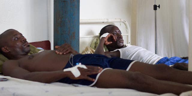 Two government soldiers, injured during Friday's fighting between the army and unidentified armed men, rest at the military hospital in Bujumbura, Burundi, Sunday, Dec. 13, 2015. Rights activists say that Friday's fighting, in which 87 people were killed in an escalation of the violence surrounding the disputed third term of President Pierre Nkurunziza, was the worst in months of turmoil since April when his candidacy was announced, and accused the security forces of extrajudicial killings of civilians. (AP Photo/Melanie Gouby)