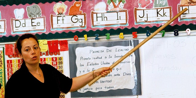 TYLER,TX - SEPTEMBER 11: Lourdes Carmona, a Spanish speaking first grade teacher, instructs a class on the Spanish pronunciations of the alphabet at Birdwell Elementary School September 11, 2003 in Tyler, Texas. Carmona, a native of Spain, was recruited 5 years ago to teach Spanish speaking youngsters reading, writing, and arithmetic in their native language, as there was and continues to be a shortage of bilingual teachers in Texas. Carmona and her husband, also a native of Spain, are both employed by the Tyler Independent School District and permanently live in the east Texas city. (Photo by Mario Villafuerte/Getty Images)