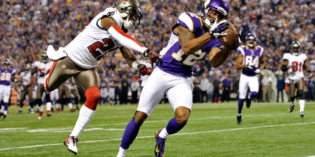 ADVANCE FOR WEEKEND EDITIONS, FEB. 16-17 - FILE - In this Oct. 25, 2013, file photo, Minnesota Vikings wide receiver Percy Harvin, right, catches an 18-yard touchdown pass ahead of Tampa Bay Buccaneers cornerback Eric Wright, left, during the first half of an NFL football game in Minneapolis. The Vikings have a quandary with Harvin: try to sign the talented but sometimes moody wide receiver to a long-term contract extension, let the last year of his current deal play out and brace for the potential distraction, or trade him. (AP Photo/Jim Mone, File)