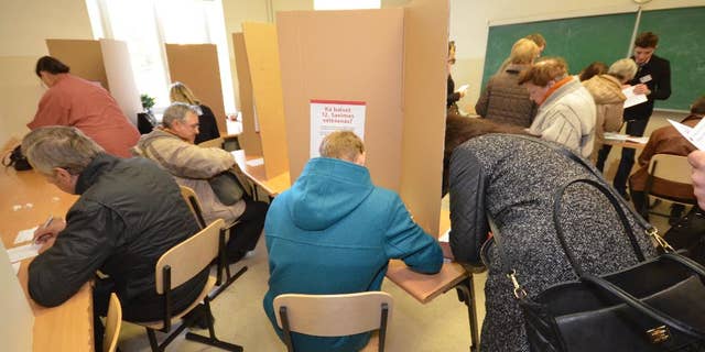 Latvian voters cast advance ballots at a high school in Riga on Thursday, Oct. 2, 2014. The Baltic country is holding a Parliamentary election on Oct. 4, amid worries over Russia’s intervention in Ukraine. (AP Photo/Tor Bernhard Slaathaug)