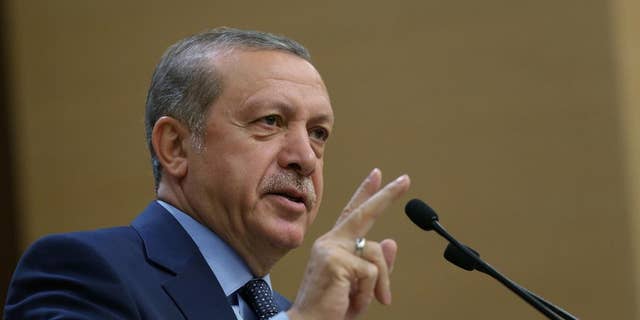 Turkey's President Recep Tayyip Erdogan addresses a group of local administrators in Ankara, Turkey, Thursday, Sept. 29, 2016. Erdogan hinted on Thursday that the three-month state of emergency declared following the failed July 15 coup could be extended to over a year. Erdogan dismissed criticism over plans for Turkey to prolong the state of emergency, saying no one should determine a "calendar or roadmap" for Turkey. (Murat Cetinmuhurdar, Prime Ministry Press Service, Pool via AP Photo)