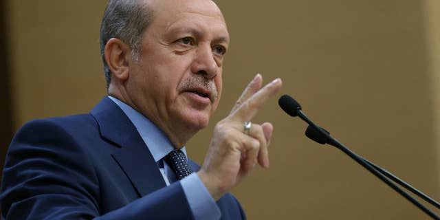 Turkey's President Recep Tayyip Erdogan addresses a group of local administrators in Ankara, Turkey, Thursday, Sept. 29, 2016. Erdogan hinted on Thursday that the three-month state of emergency declared following the failed July 15 coup could be extended to over a year. Erdogan dismissed criticism over plans for Turkey to prolong the state of emergency, saying no one should determine a "calendar or roadmap" for Turkey. (Murat Cetinmuhurdar, Prime Ministry Press Service, Pool via AP Photo)