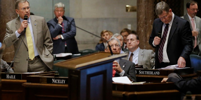 April 4, 2016: Sen. Ferrell Haile, R-Gallatin, left, speaks during debate on a bill by Sen. Steve Southerland, R-Morristown, front right, to make the Holy Bible the official book of Tennessee.