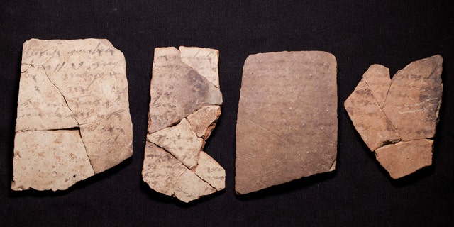 Letters inscribed on pottery, known as ostracons, which were unearthed in an excavation of a fort in Arad, Israel, and dated to about 600 B.C. shortly before Nebuchadnezzar's destruction of Jerusalem, are seen in Israel Museum in Jerusalem Tuesday, April 12, 2016. (AP Photo/Dan Balilty)