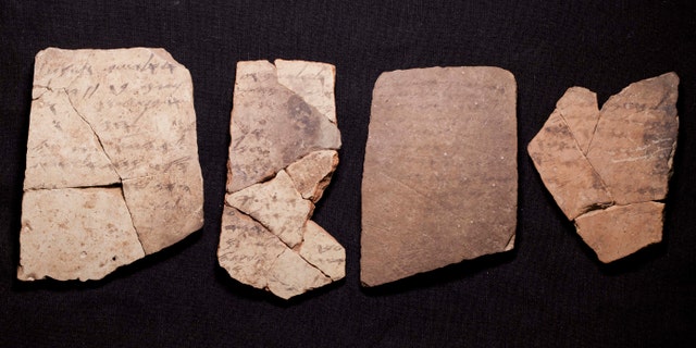 Letters inscribed on pottery, known as ostracons, which were unearthed in an excavation of a fort in Arad, Israel, and dated to about 600 B.C. shortly before Nebuchadnezzar's destruction of Jerusalem, are seen in Israel Museum in Jerusalem Tuesday, April 12, 2016. (AP Photo/Dan Balilty)