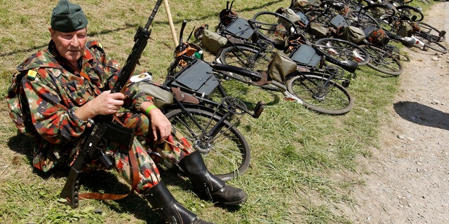 File photo - A participant dressed as soldier of the former Swiss bicycle regiment rests during the Convoy-to-Remember 2010 meeting in the village of Birmenstorf, west of Zurich August 7, 2010. (REUTERS/Arnd Wiegmann)