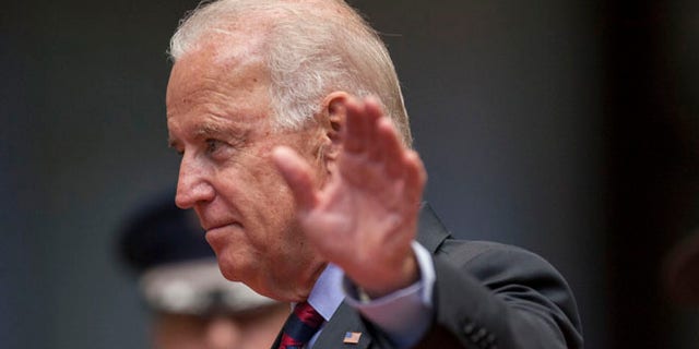 U.S. Vice President Joe Biden waves to photographers at the National Palace in Guatemala City, Friday, June 20, 2014.
