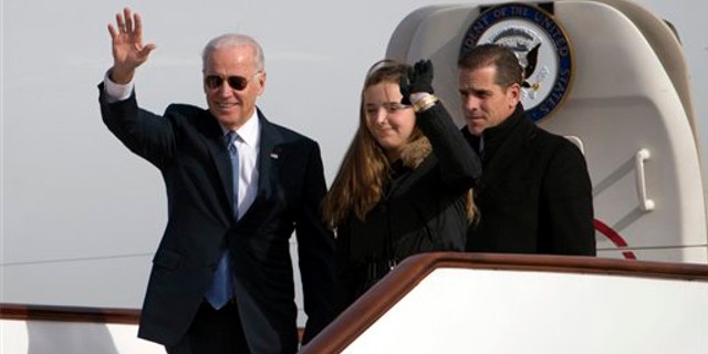 Dec. 4, 2013: Vice President Joe Biden, left, waves as he walks out of Air Force Two with his granddaughter Finnegan Biden and son Hunter Biden at the airport in Beijing. (Associated Press)