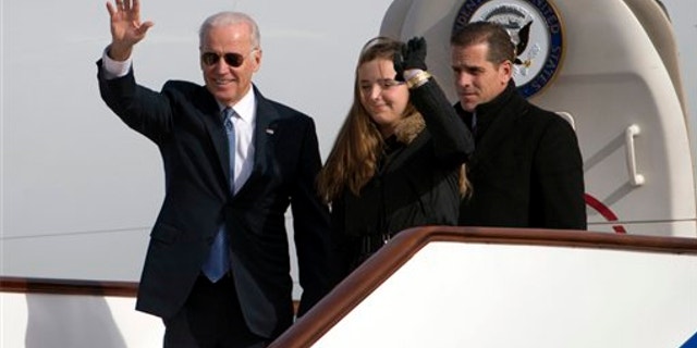 Dec. 4, 2013: Vice President Joe Biden, left, waves as he walks out of Air Force Two with his granddaughter Finnegan Biden and son Hunter Biden at the airport in Beijing, China.
