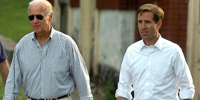 FILE: July 4, 2012: Delaware Attorney General Beau Biden, right, takes a walk with his father,Vice President Joe Biden, to the Green Ridge Little Baseball Field in Scranton, Pa.
