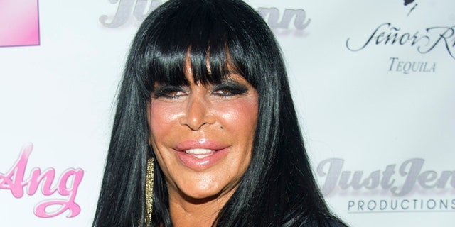 July 8, 2012. Angela Raiola, known as "Big Ang," and her dog Little Louie arrive to the premiere of her VH1 reality show "Big Ang" in New York.