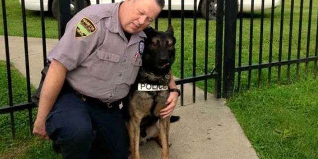 Matthew Hickey puts his arms around K-9 partner Ajax.