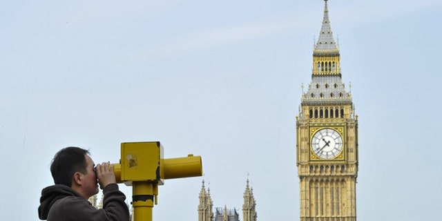 May 6: A man looks through a telescope opposite Big Ben and the Houses of Parliament, in central London.