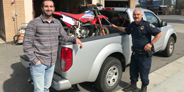 Kamron Golbaf retrieving his motorcycle from CHP officer Ralph Villegas at the Temecula station.