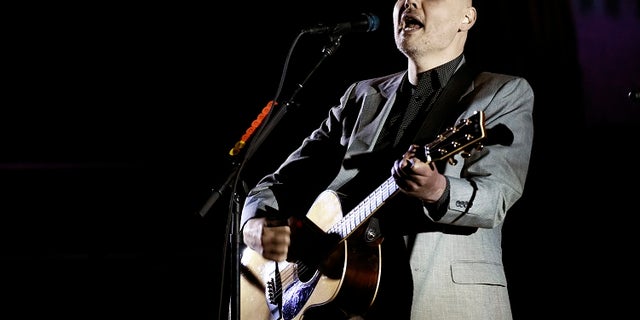 D'arcy Wretzky claims Billy Corgan (above) invited her to be part of the reunion but then rescinded the offer.