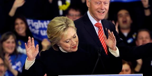 Democratic presidential candidate Hillary Clinton reacts as former President Bill Clinton smiles at her New Hampshire presidential primary campaign rally, Tuesday, Feb. 9, 2016, in Hooksett, N.H. (AP Photo/Elise Amendola)