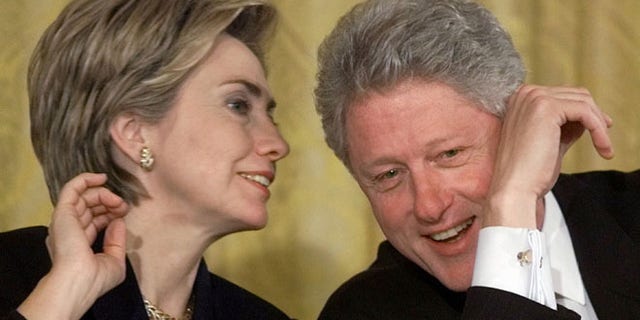 Oct. 22, 1999: President Bill Clinton and first lady Hillary Rodham Clinton talk during the White House Conference on Philanthropy in the East Room of the White House in Washington.