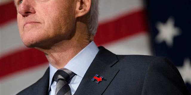 Former President Bill Clinton wears a campaign pin for his wife, Democratic presidential candidate Hillary Clinton, as he campaigns for her on Feb. 12, 2016, at the Clifton Cultural Arts Center in Cincinnati. (AP Photo/John Minchillo)