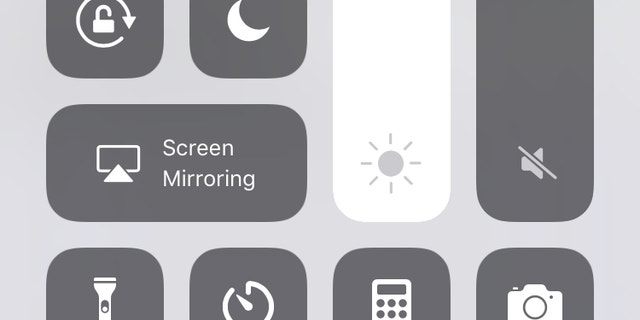 Adjust brightness manually by swiping up and moving the sun icon up and down.