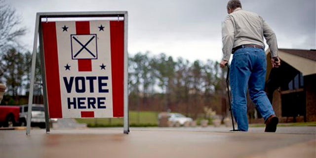 A voter leaves a polling place in Birmingham, Ala. in 2012