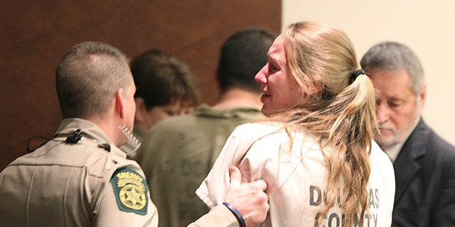 Kayla Norton yells "I love you guys!" to the crowd that gathered to support her at her sentencing at the Douglas County Courthouse in Douglasville, Ga., Monday, Feb. 27, 2017. Superior Court Judge William McClain sentenced Norton and Jose Torres to lengthy prison terms Monday for their role in the disruption of a black child's birthday party with Confederate flags, racial slurs and armed threats. (Henry P. Taylor/Atlanta Journal-Constitution via AP)