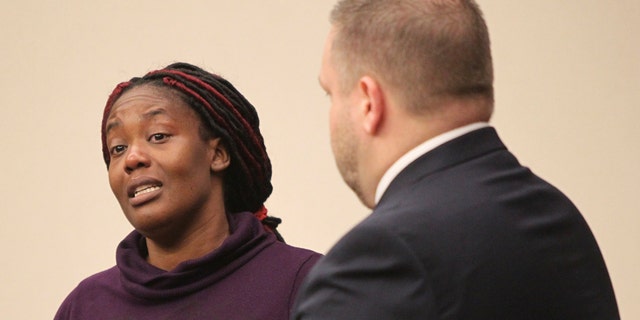 Hyesha Bryant stands and speaks to Kayla Norton and the court around her in response to Norton speaking on her own behalf while District Attorney Brian Fortner stands at her side at the Douglas County Courthouse in Douglasville, Ga., on Monday, Feb. 27, 2017. Superior Court Judge William McClain sentenced Jose Torres and Norton to lengthy prison terms Monday for their role in the disruption of a black child's birthday party with Confederate flags, racial slurs and armed threats. (Henry P. Taylor/Atlanta Journal-Constitution via AP)