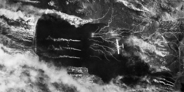 The Germans release a colossal smoke screen in an effort to hide their battleship Tirpitz, moored in Kaa Fjord, Norway, as it's attacked by a Lancaster on Sept. 15, 1944. (Credit: No. 5 Group RAF/IWM)