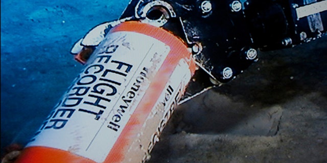 May 1, 2011: A mechanical arm, seen in this image published on the web site of France's BEA air accident inquiry offic, holds an orange cylindrical flight data recorder above the sand.