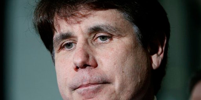In this June 9 photo, former Illinois Gov. Rod Blagojevich pauses as he talks with reporters at the Federal Court building in Chicago.