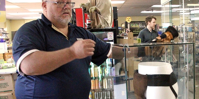 Blockbuster Alaska General Manager Kevin Daymude moves a display case featuring the jockstrap worn by actor Russell Crowe in the 2005 movie "Cinderella Man" at a Blockbuster video store in Anchorage, Alaska.