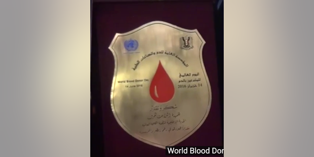 English translation of award received by WHO’s Elizabeth Hoff: The General Establishment for Blood and Medical Industries/World Blood Donor Day 14 June 2016/Thank you and appreciation/Ms Elizabeth Hoff, WHO Regional Representative/For her efforts to develop and support the institution