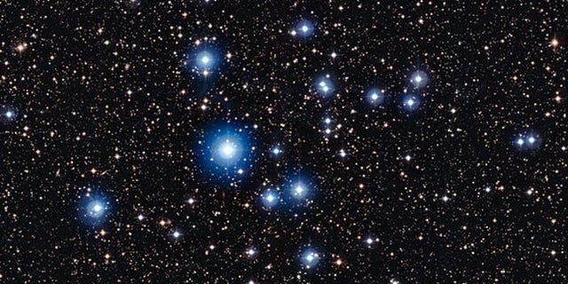 This image from the Wide Field Imager on the MPG/ESO 2.2-metre telescope at ESOs La Silla Observatory in Chile, shows the bright open star cluster NGC 2547. Between the bright stars, far away in the background of the image, many remote galaxies can be seen, some with clearly spiral shapes.