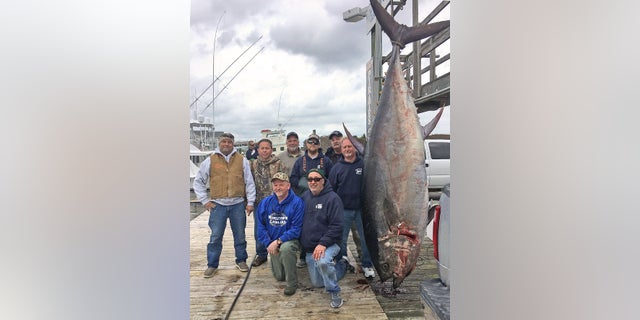 Scott Chambers, (kneeling, left) a retired Army general, caught the bluefin on March 17.