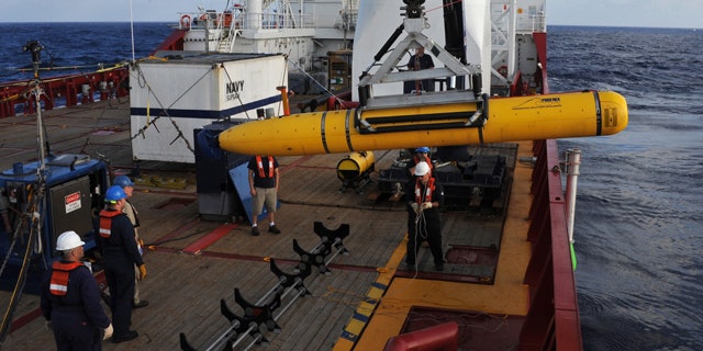 April 14, 2014: Operators aboard ADF Ocean Shield move U.S. Navy's Bluefin-21 into position for deployment.