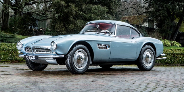 A classic BMW only owned by the motorsport hero John Surtees is set to sell for more than £2 MILLION at auction. See SWNS story SWSURTEES; The late icon snapped up the BMW 507 Roadster new in 1957 after winning the 500cc Motorcycle World Championship a year earlier. Surtees had fallen in love with the stunning German sports car at the Hockenheim race track and decided he had to own one. And he didnât have to pay full whack - with Count Agusta, the owner of the racing team Surtees rode for, paying half of the £3,000 price as a reward for his track heroics. The silver sports car was one of the most elegant motors of its time and is one of the most valuable BMWs on the planet. It is powered by 3.2-litre V8 engine which gives it a 0-60mph time of less than ten seconds and a top speed of around 130mph. John Surtees still owned the BMW when he passed away in 2017 at the age of 84. He remains the only person to win the world championship on two and four wheels.
