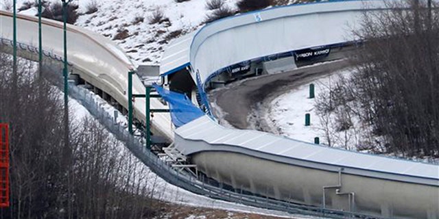 A tarp covers the intersection of the bobsled and luge tracks at Canada Olympic Park in Calgary, Canada, on Saturday, Feb. 6, 2016. Calgary police say emergency crews were called to the WinSport facility in northwest Calgary early in the morning after a report of several injured people on a closed track. Eight teenagers, all males, entered the property after hours and used toboggans to go down the bobsled track. (Larry MacDougal/The Canadian Press via AP) MANDATORY CREDIT