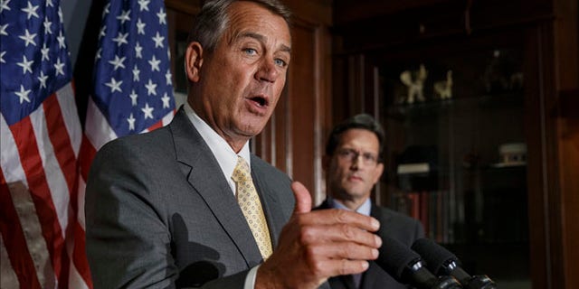 Jan. 28, 2014: House Speaker John Boehner, left, with House Majority Leader Eric Cantor, talks with reporters at Republican National Committee headquarters in Washington.