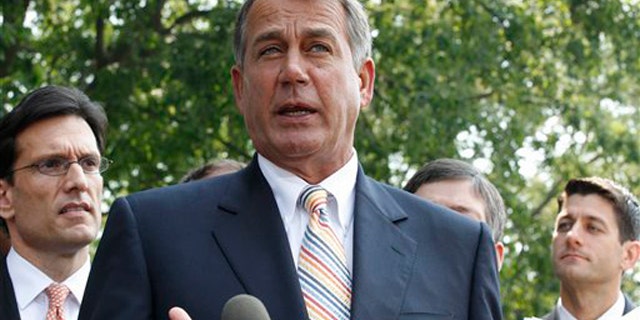 House Speaker John Boehner, center, stands with, from left, House Majority Leader Eric Cantor and House Budget Committee Chairman Paul Ryan, as he speaks to reporters outside the White House in Washington June 1.