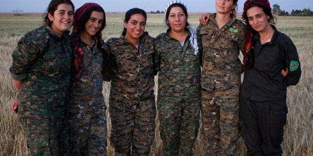 Böhman is pictured with other members of the YPJ – the female brigade of the Kurdish People's Protection Units.