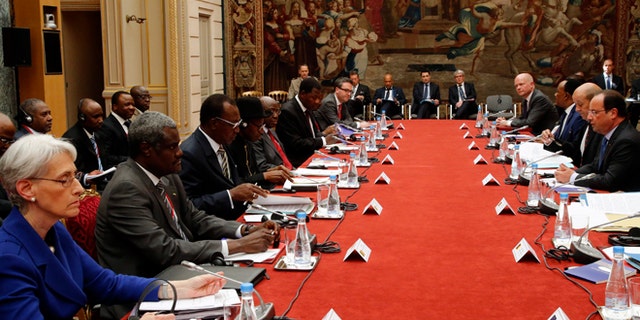 May 17, 2014: U.S. Undersecretary of State for Political Affairs Wendy Sherman, left, looks on as French President Francois Hollande, right, talks during the round table photo session at the "Paris' Security in Nigeria summit", at the Elysee Palace, in Paris.