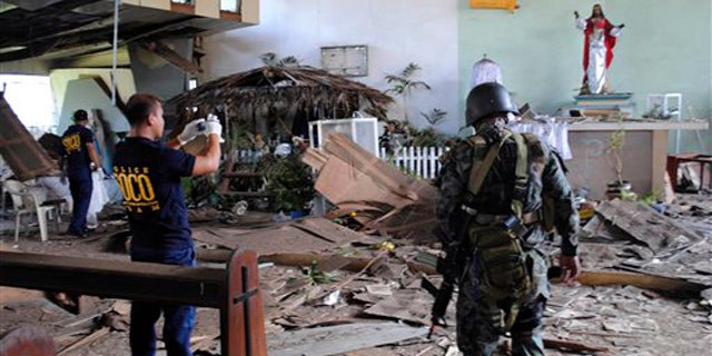 Dec. 25, 2010: Philippine National Police investigators inspect the damage of the Sacred Heart Catholic chapel following an explosion during a Christmas Day mass at the volatile island of Jolo, Sulu province in southern Philippines.