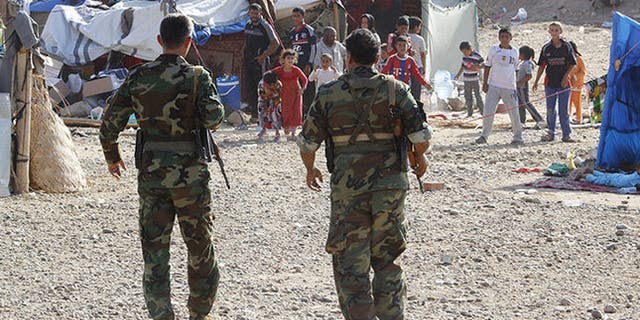 Kurdish Peshmerga forces patrol near a family that fled ISIS in Jasim Mohammed Atti'ya's hometown of Hawijah, Iraq.
